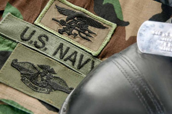 70783045 featured image U.S. Navy badges on camouflage uniform with boot