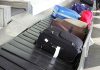 Suitcases on an airport baggage carousel.