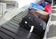 Suitcases on an airport baggage carousel.