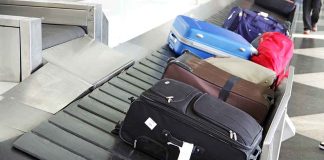 Suitcases on an airport baggage carousel.