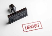 Rubber stamp labeled lawsuit on white background