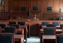 Empty courtroom with wooden furnishings and judge's bench