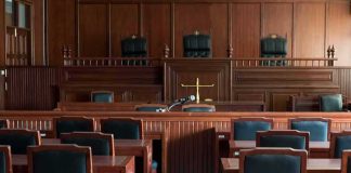 Empty courtroom with wooden furnishings and judge's bench