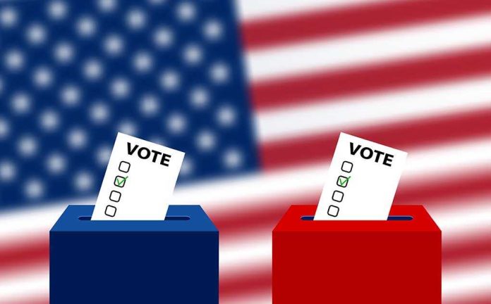1194465994 featured image Ballots in boxes with American flag background