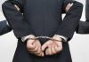 Person handcuffed in suit