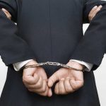 Person handcuffed in suit