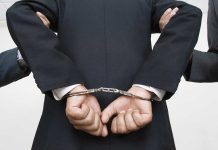 Person handcuffed in suit
