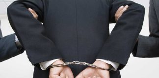 Person handcuffed in suit