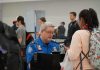 TSA agent checks passenger's documents at airport security