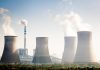 Four cooling towers of a power plant emitting steam
