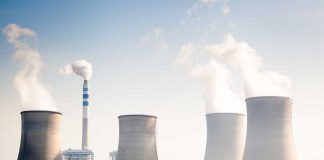 Four cooling towers of a power plant emitting steam