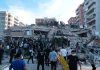 People at a collapsed building after an attack