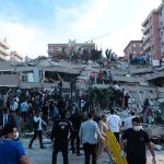 People at a collapsed building after an attack