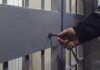 Hand unlocking metal jail cell door with key