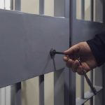 Hand unlocking metal jail cell door with key