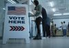 Sign reading Vote Here in a polling station