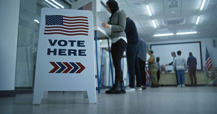 2451104599 featured image Sign reading Vote Here in a polling station