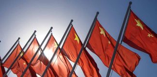 Red flags with yellow stars on flagpoles