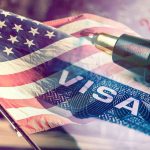 US flag overlaying visa and pen