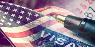 US flag overlaying visa and pen