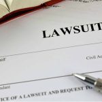 Lawsuit document with pen and open book