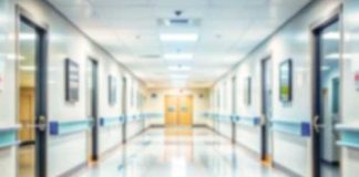Blurred hospital corridor with doors and lights