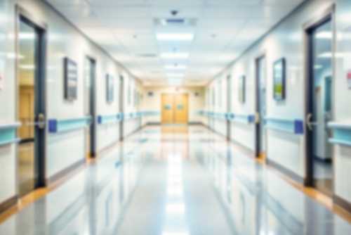 hospital hallway_2464656035.jpg featured image Blurred hospital corridor with doors and lights