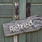 Rustic retired sign on green wooden door
