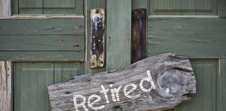 Rustic retired sign on green wooden door