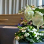 White roses in front of a casket