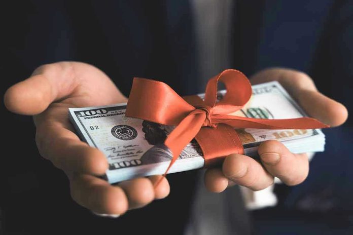 1690384846 Hands holding stack of hundred dollar bills with ribbon