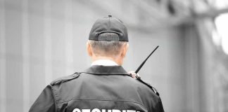 Security guard holding a walkie talkie