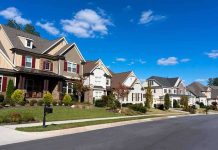 A row of modern suburban houses under a clear blue sky