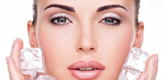 Close up of a woman holding ice cubes around her face