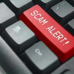 Close-up of keyboard with red SCAM ALERT key.