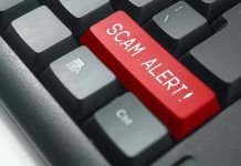 Close-up of keyboard with red SCAM ALERT key.