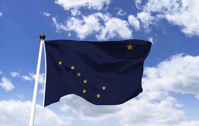 Alaska state flag flying against a blue sky