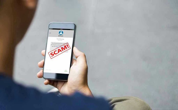 2058303887 Person reading a scam message on a smartphone.