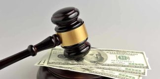 Gavel resting on hundred dollar bills