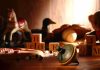 A wooden spinning top surrounded by vintage toys and colorful blocks