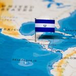 Map of Central America with a flag of El Salvador pinned on it