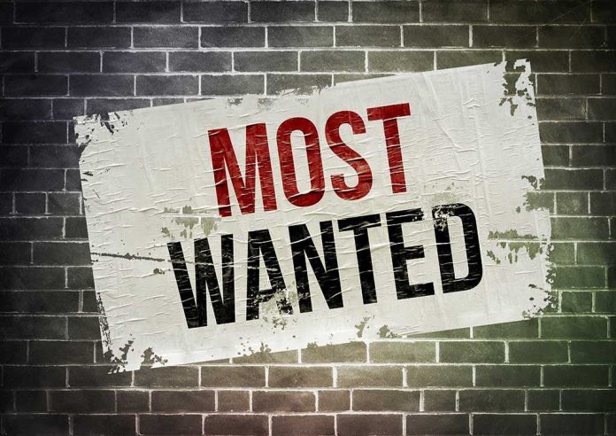 shutterstock_227310661.jpg A weathered poster displaying the words MOST WANTED on a brick wall