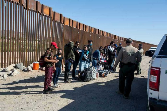1973414822 Border patrol agents interact with a group of people.