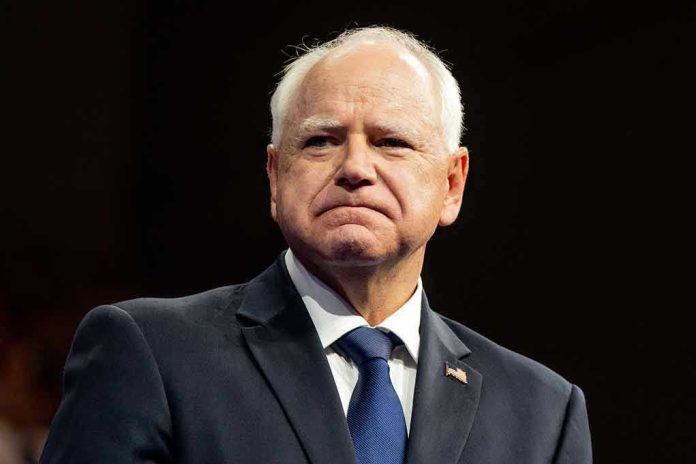 Man in suit with a U.S. flag pin.