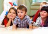 A group of children enjoying playtime indoors, displaying joyful expressions