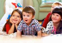 A group of children enjoying playtime indoors, displaying joyful expressions