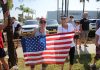 Two women holding an American flag at a community event