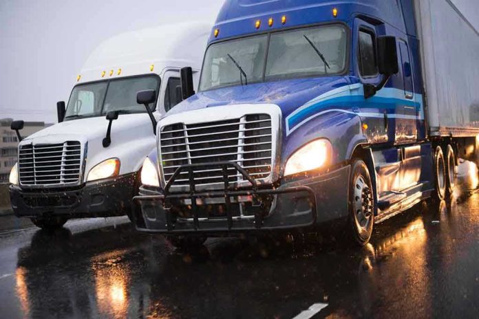 1011507415 Two trucks driving on a wet road.