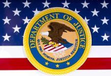 Bounty Placed on Bondi – FBI Raids Anarchist! Department of Justice seal on American flag background.