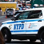Woman Mows Down Officer – Receives ZERO Punishment! NYPD police car on a city street scene.